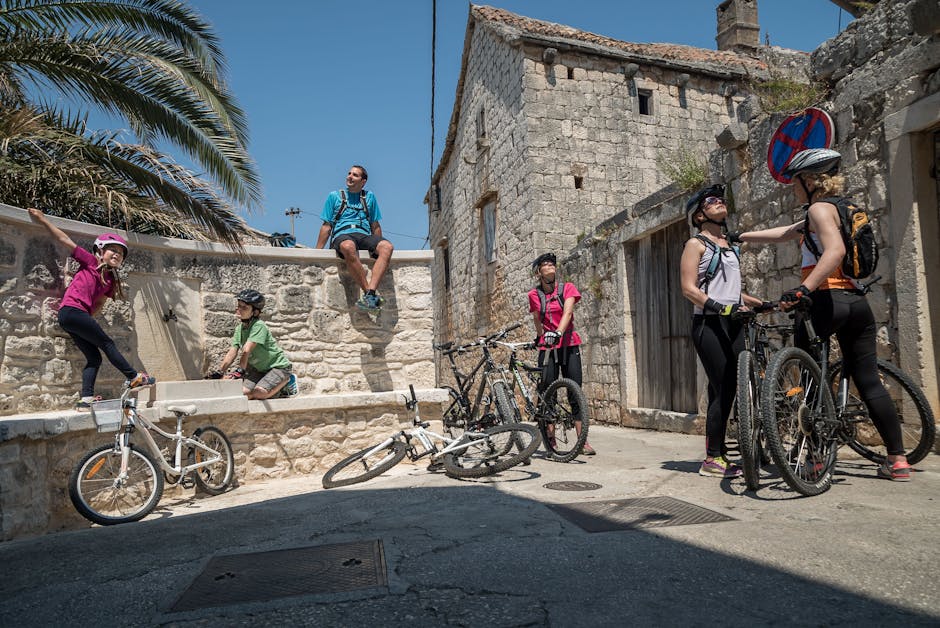 family cycling Lucca narrow street