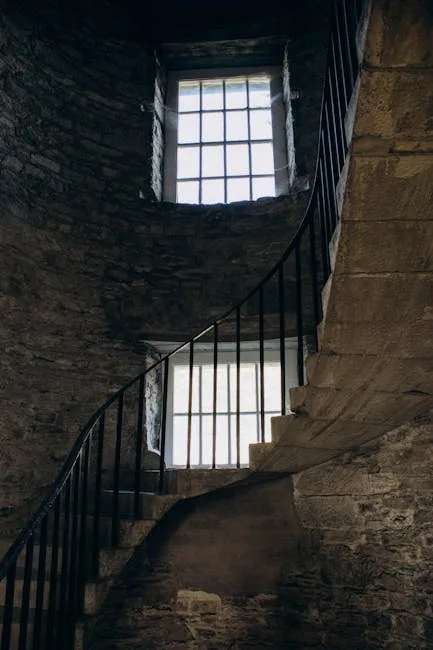 Narrow stone spiral staircase inside a medieval tower in Lucca