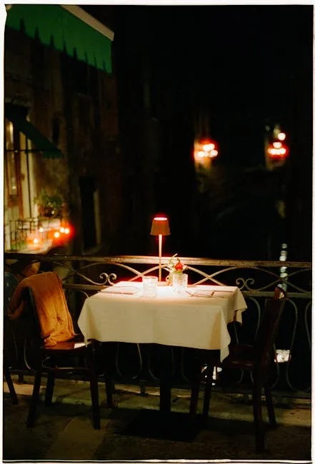 Romantic candlelit dinner table on a Lucca balcony at night