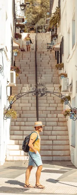 Man with backpack and hat walking by tall stone steps decorated with flowers