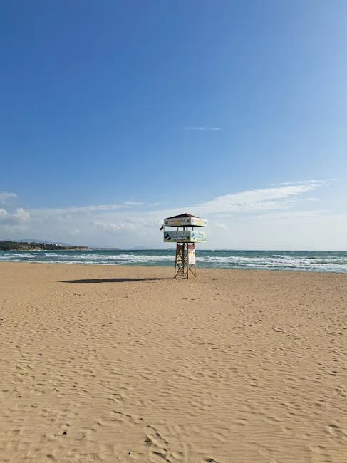 Solitary lifeguard tower standing on Versilia sandy beach under blue sky