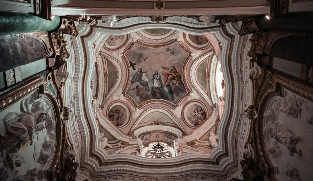 Ornate Baroque ceiling frescoes and stucco decorations inside a Lucca church