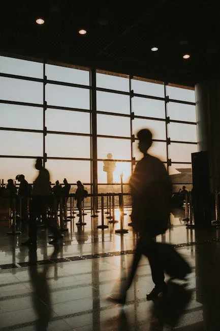 Silhouetted travelers walking through Pisa airport terminal at sunset