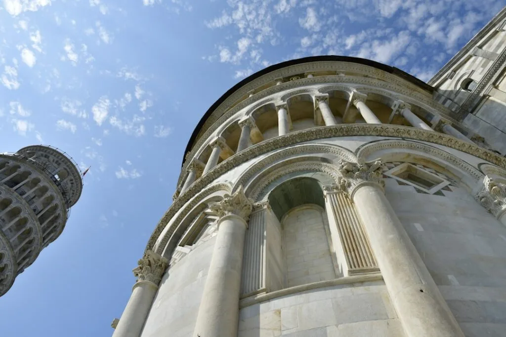 Low-angle view of Pisa cathedral and Leaning Tower architectural details