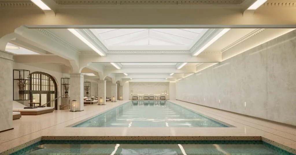 Elegant indoor spa pool with skylights and lounge chairs in Bagni di Lucca