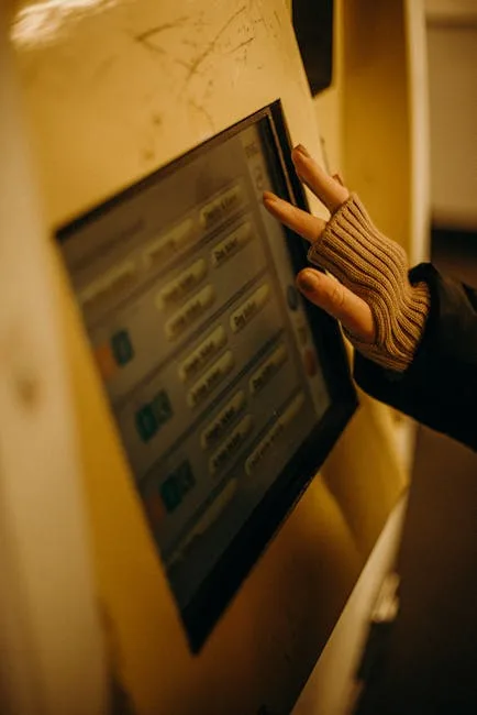 Hand with fingerless glove touches train ticket kiosk screen in Lucca