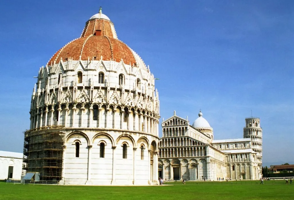 Pisa Baptistry and cathedral complex with Leaning Tower in background