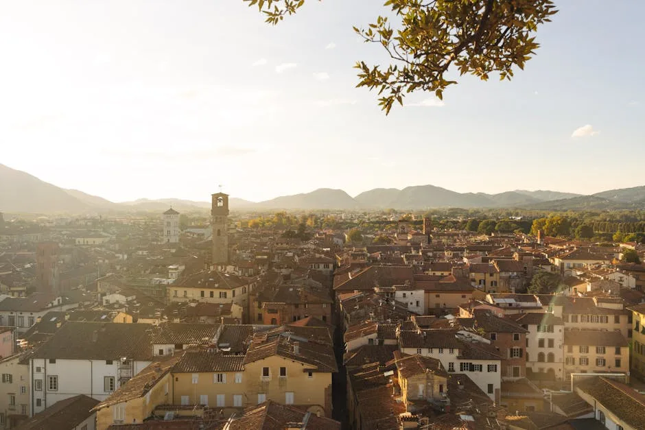 Sunlit panorama of Lucca's terracotta rooftops and distant hills