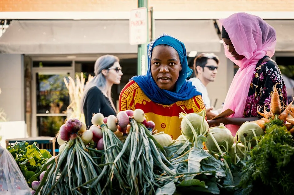 Two market vendors at Lucca stall arranging fresh vegetables and kohlrabi.