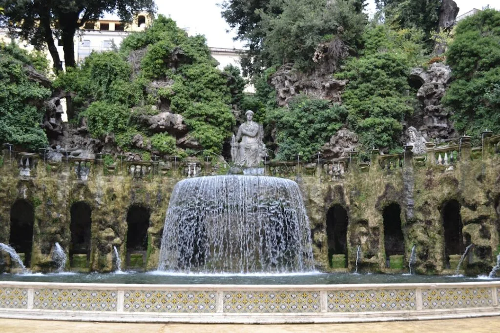Cascading central fountain set against a rocky grotto in Lucca