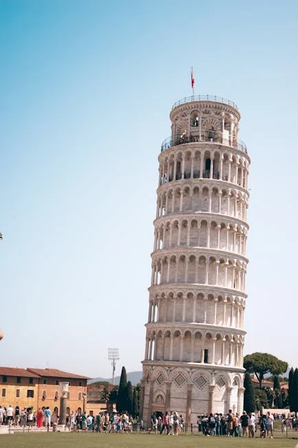 Crowds gathered around Pisa's Leaning Tower on a sunny day