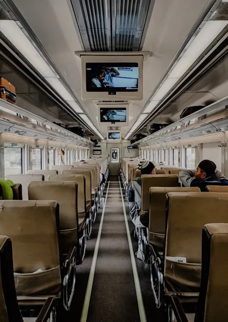 Interior of regional train to Lucca with overhead screens and seats
