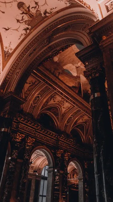 Ornate carved columns and frescoed vaulted ceiling inside historic Italian church