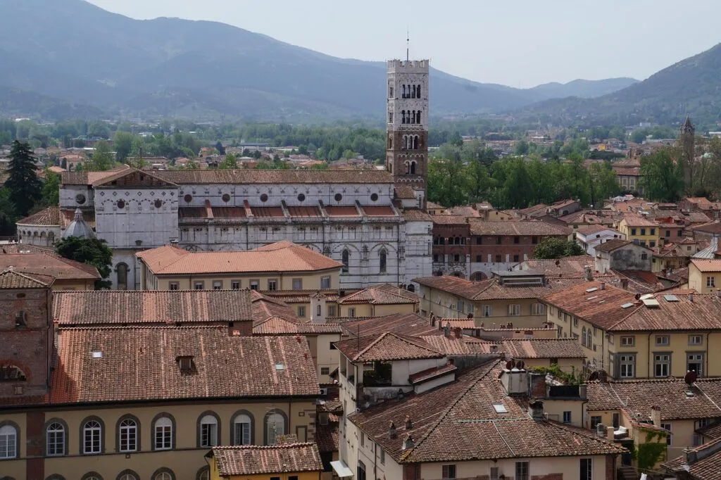 Rooftops and cathedral tower of Lucca with surrounding Tuscan hills