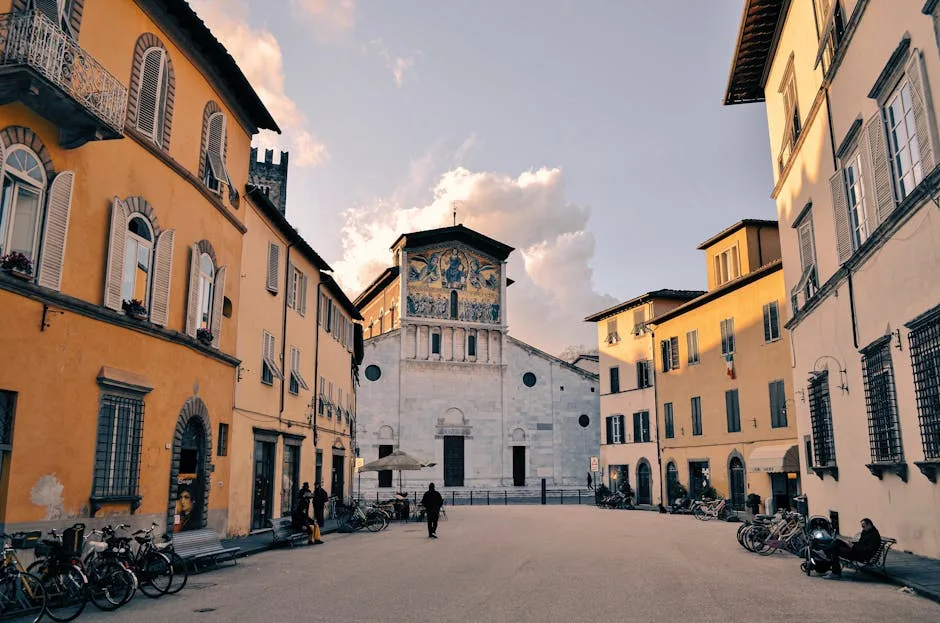 San Frediano's mosaic facade framed by ochre buildings and parked bicycles, Lucca