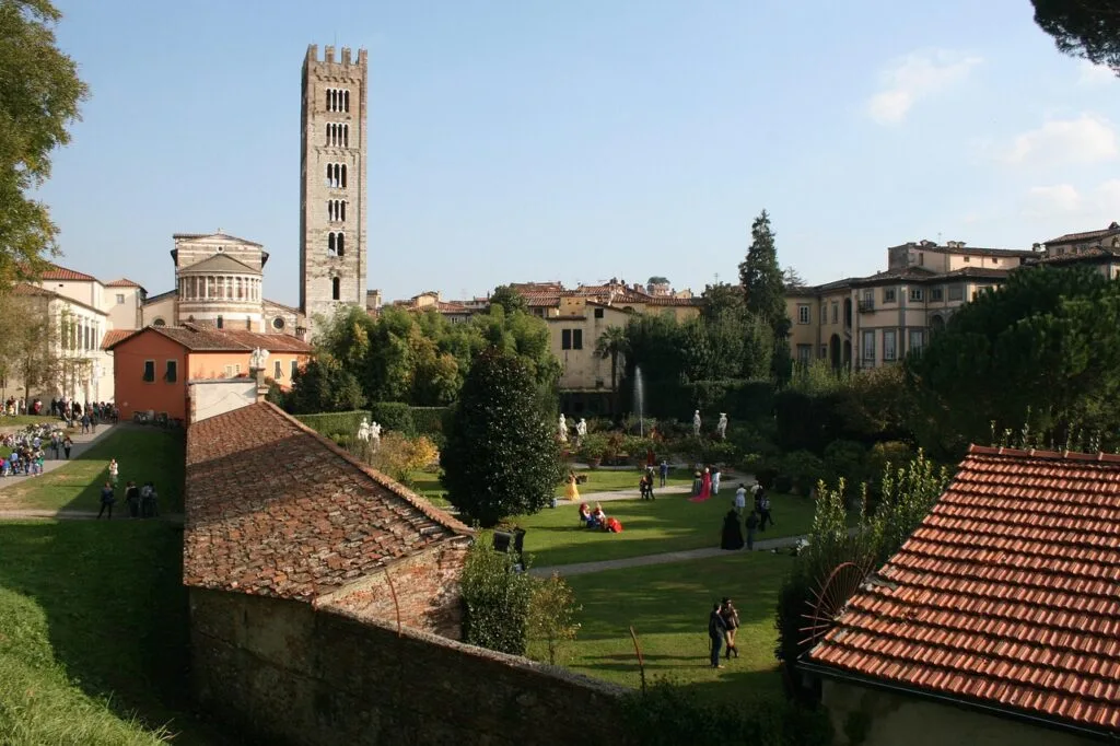 Lucca garden inside city walls with tower and people in costumes