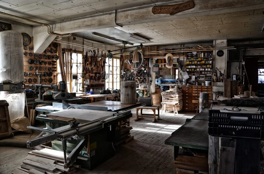 Sunlit woodworking studio with tools and machines in a Lucca workshop
