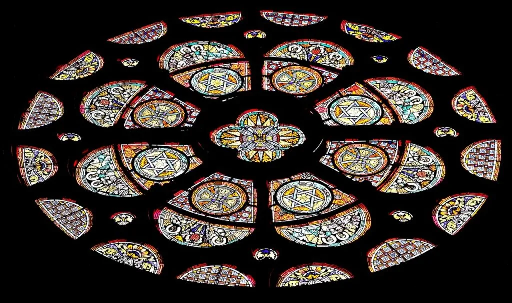 Circular rose window with star motifs high above Lucca cathedral